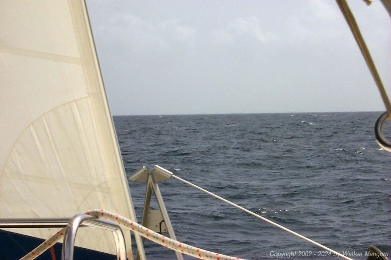 Approaching Anegada. It is slightly hazy and we are 6 miles from the entrance buoys. If you know what you are looking for, you can see the Australian pines at Setting Point Villa on the horizon.