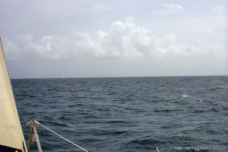 Approaching Anegada. It is slightly hazy and we are 4 miles from the entrance buoys. If you know what you are looking for, you can see the Australian pines at Setting Point Villa, the palm trees at Neptune's Treasure, and the Australian pines at Setting Point on the horizon.