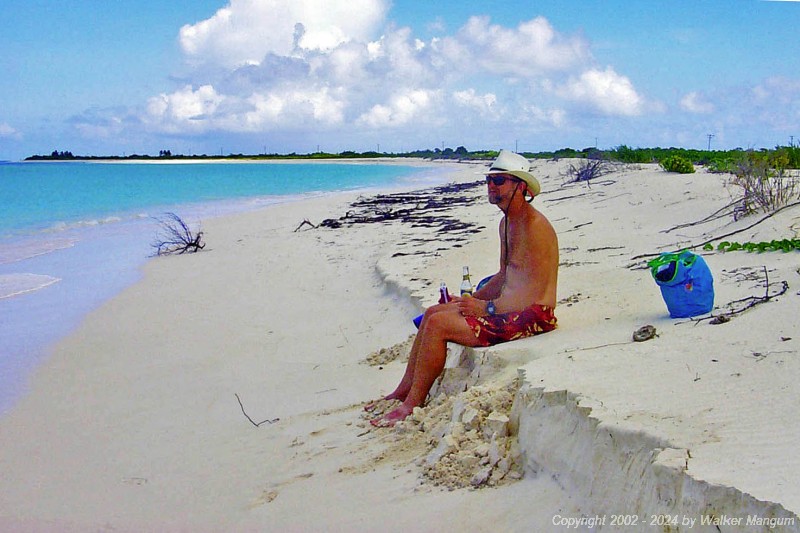 Walker taking a Carib break during the walk to Cow Wreck Beach. This is on the west end of Anegada at "Half-Way" Point. Ruffling Point and West End Point are visible in the distance.