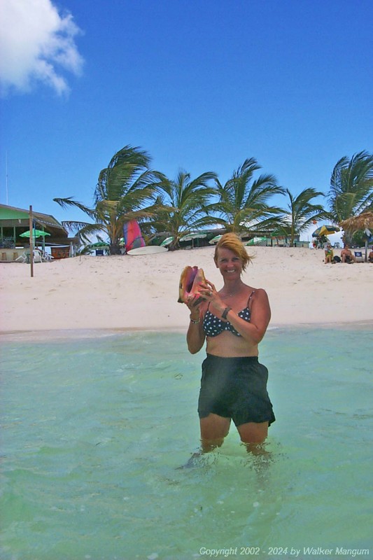 Nancy with a live queen conch that she picked up in the water at Cow Wreck Beach.