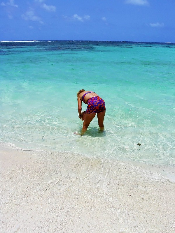 Nancy with a conch shell at Nancy and Walker's secret beach on Anegada