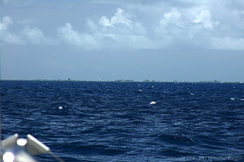 Anegada on the horizon. This photo was taken with a telephoto lens from four miles out. It is what you would see with a good pair of binoculars.