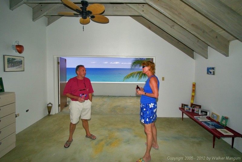 Malcolm Boyes and Nancy at Malcolm's "Chateau Relaxeau Caribe" on Little Apple Bay.  The view looks like a painting!