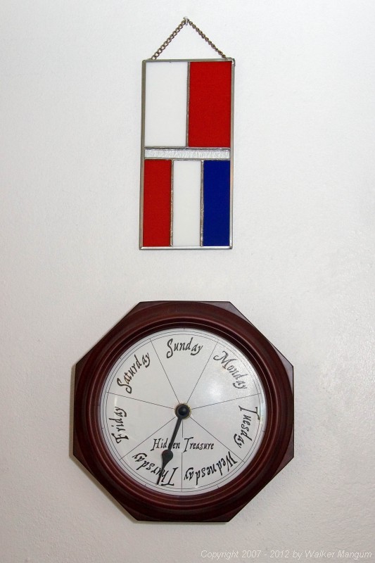 "HT" nautical signal flag stained glass hanging above our Hidden Treasure clock. The stained glass was a housewarming gift from some very good friends. Thanks Beth, Gary, Tyler, and Connor Thiret!
The single hand of the clock takes a week to make the trip around the face. 