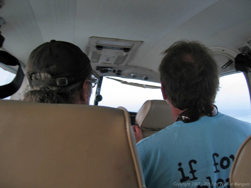 Flying into Anegada on Island Birds. The back of Davide and Walker's heads.