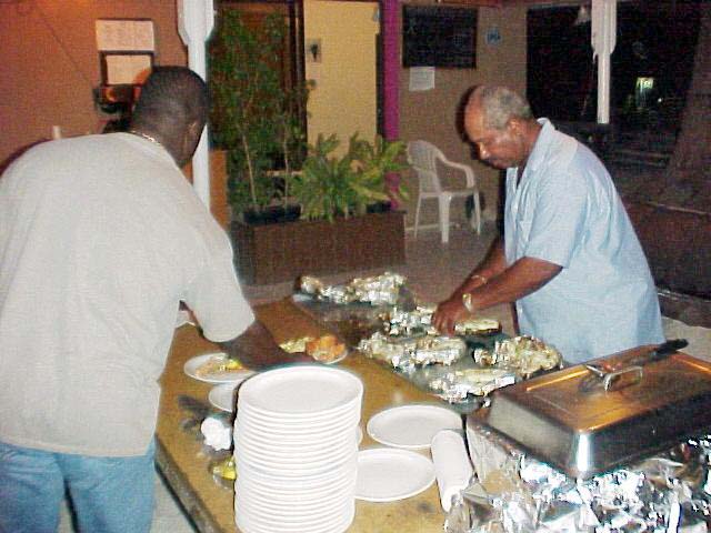 Lowell putting finishing touch on dinner, 2002